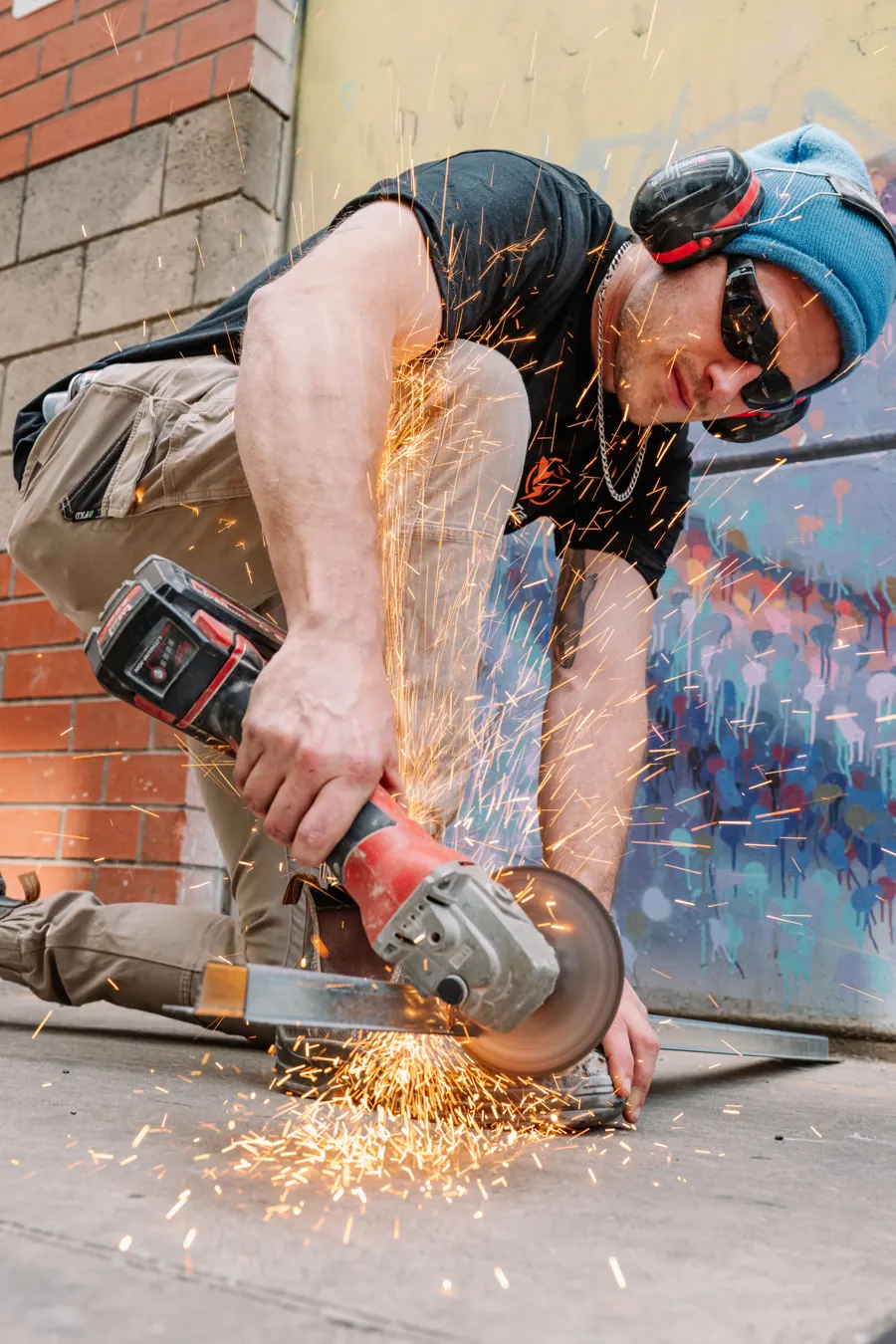 Cutting steel with an angle grinder, sparks flying